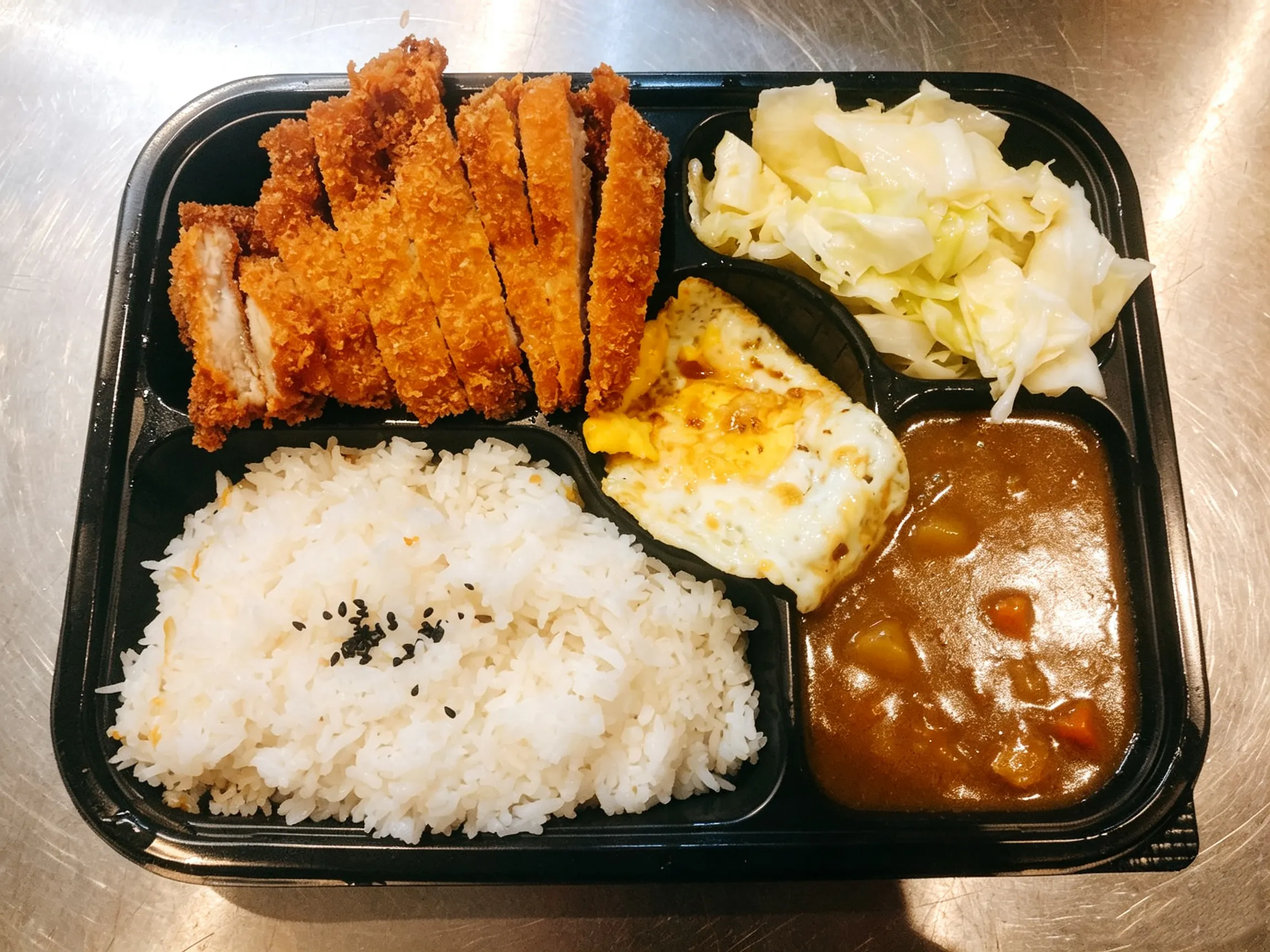Katsu curry bento box with rice, fried pork cutlet, egg and cabbage at Yijia Kitchen，a Chinese Restaurant in Arcadia