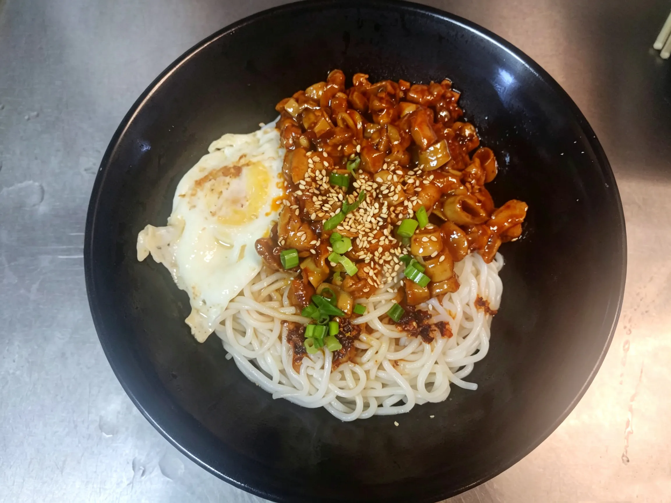 Dry rice noodles with diced meat sauce, fried egg, sesame seeds and green onions at Yijia Kitchen，a Chinese Restaurant in Arcadia