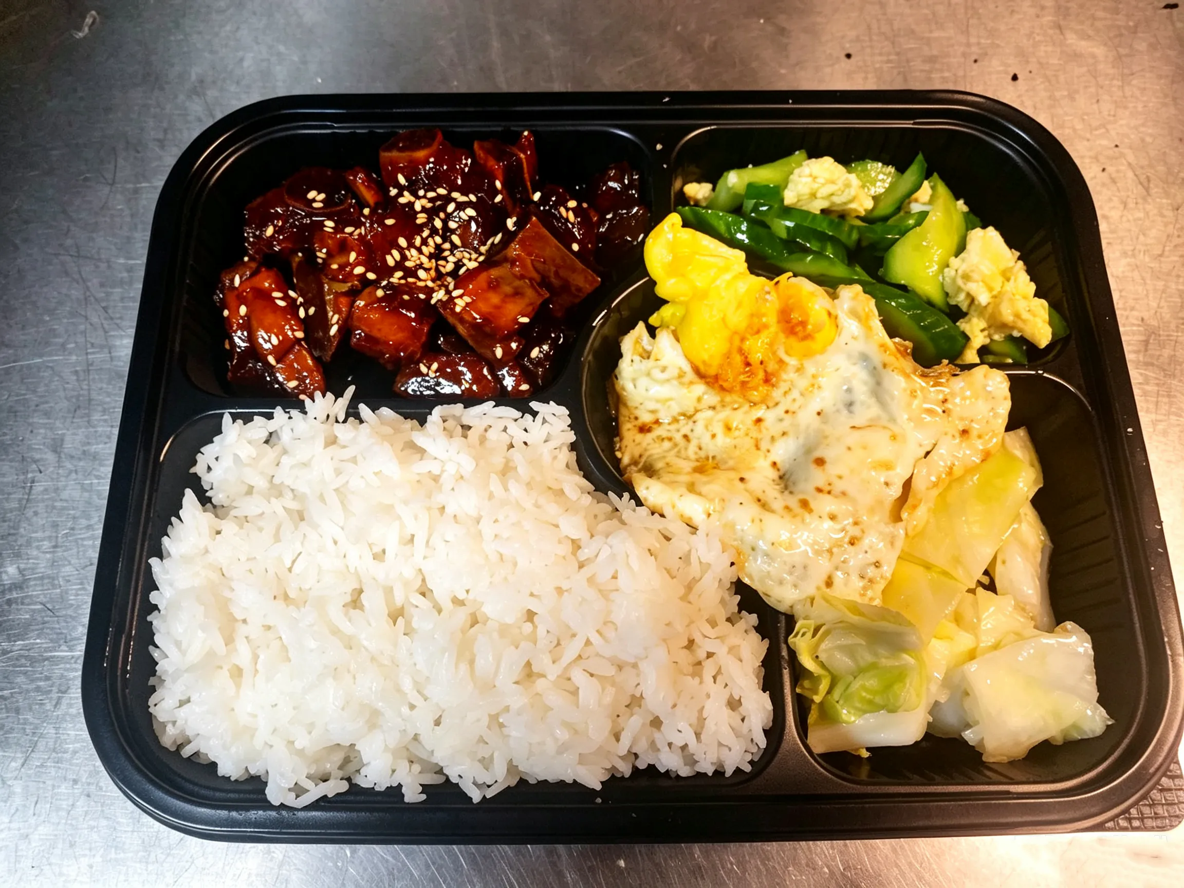 Rib bento box with steamed rice, fried egg and mixed vegetable sides at Yijia Kitchen，a Chinese Restaurant in Arcadia