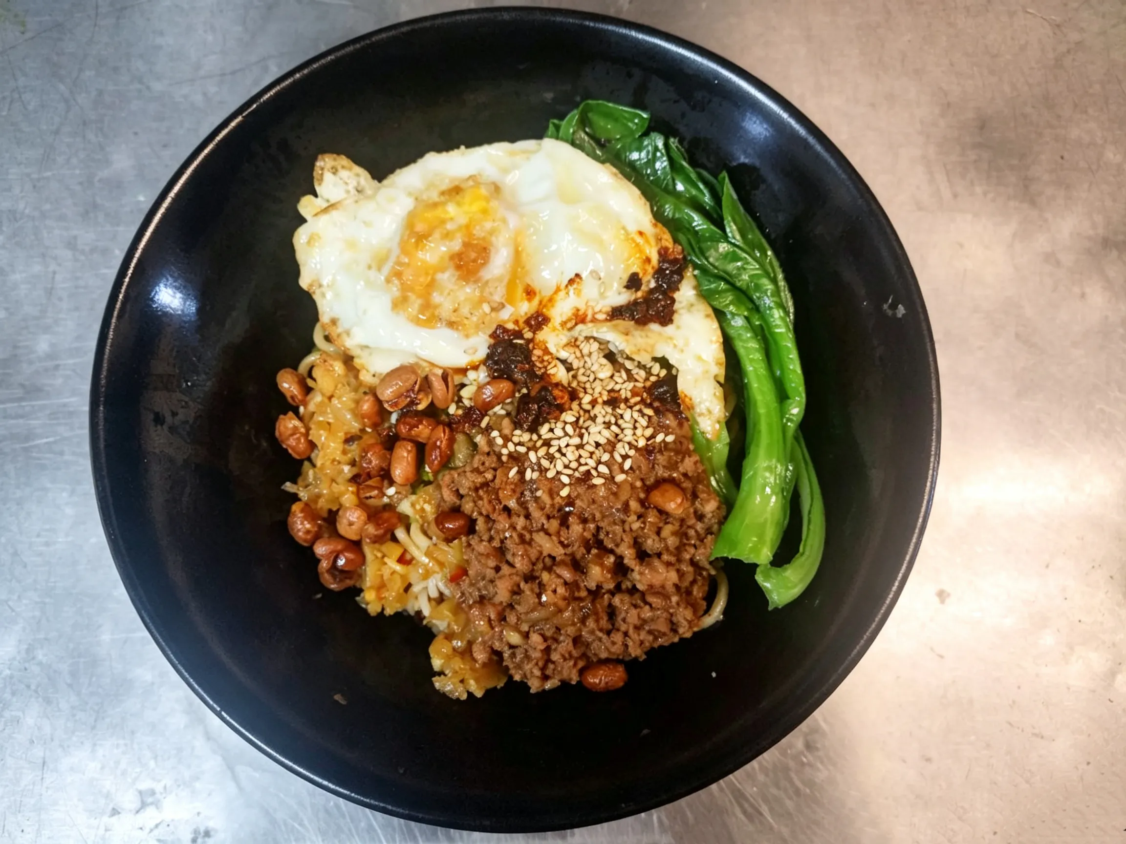 Bolognese spicy dry noodles topped with minced pork, fried egg, peanuts and leafy greens at Yijia Kitchen，a Chinese Restaurant in Arcadia
