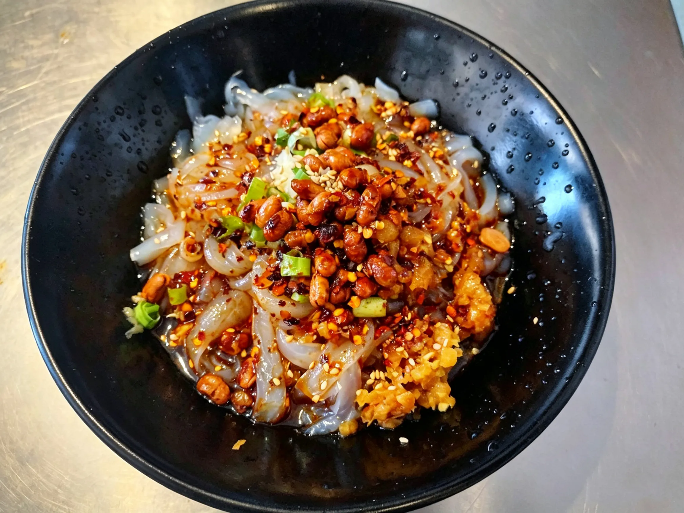 Spicy cold jelly noodles garnished with peanuts, garlic, green onions and chili oil at Yijia Kitchen，a Chinese Restaurant in Arcadia